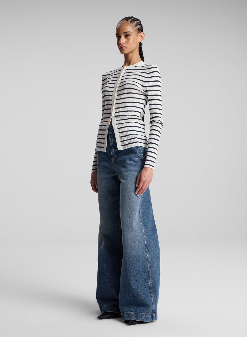 woman wearing white and navy blue striped cardigan and jeans