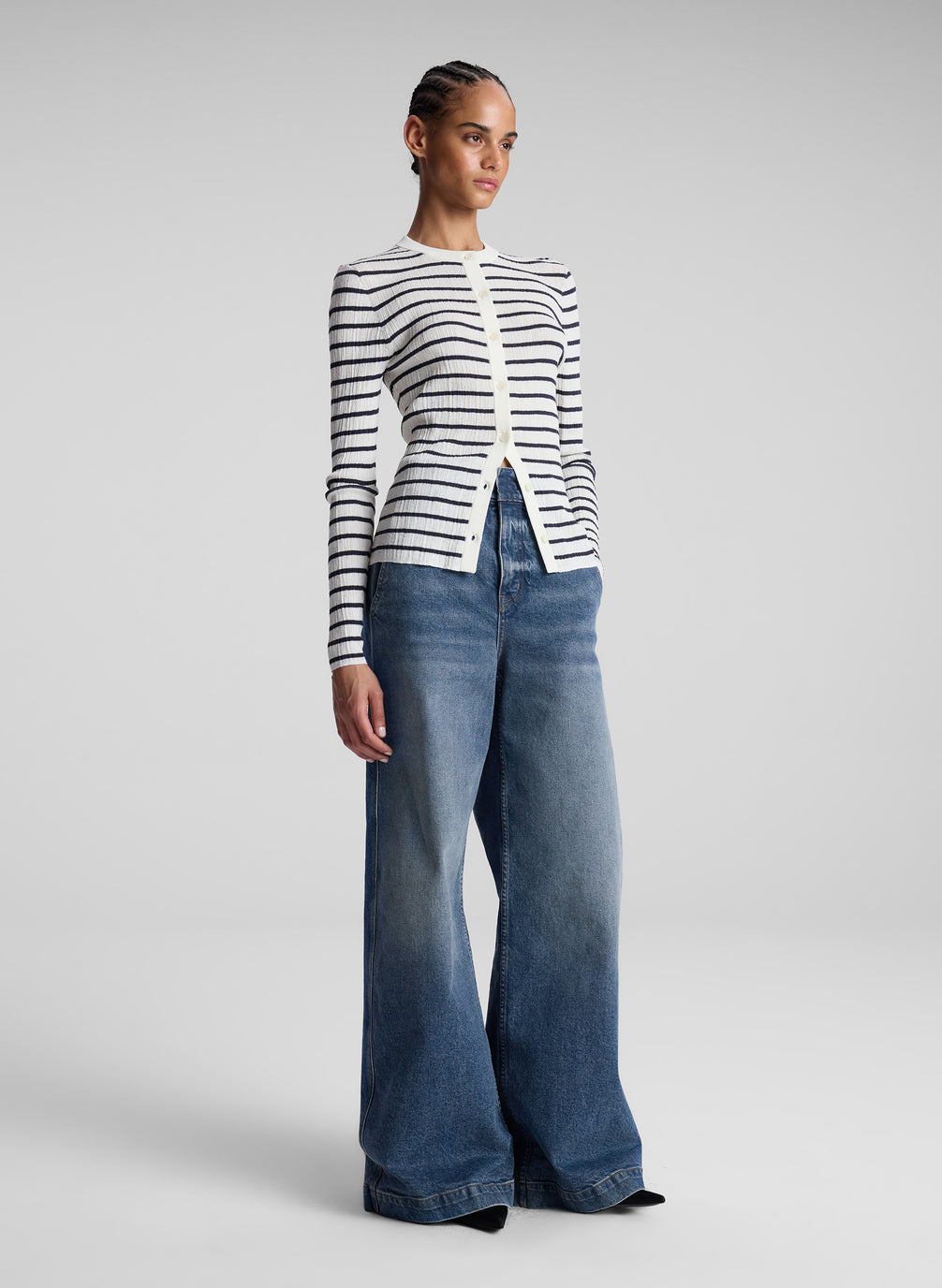 woman wearing white and navy blue striped cardigan and jeans