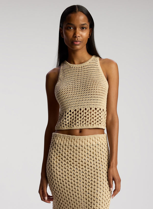 front view of woman wearing tan crochet top and skirt set
