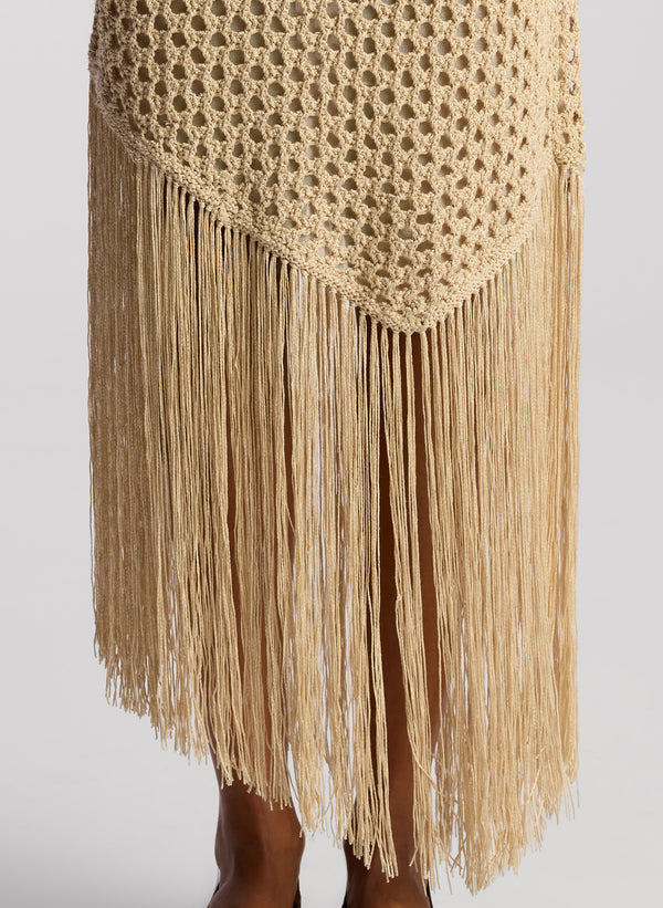 detail view of woman wearing tan crochet top and skirt set