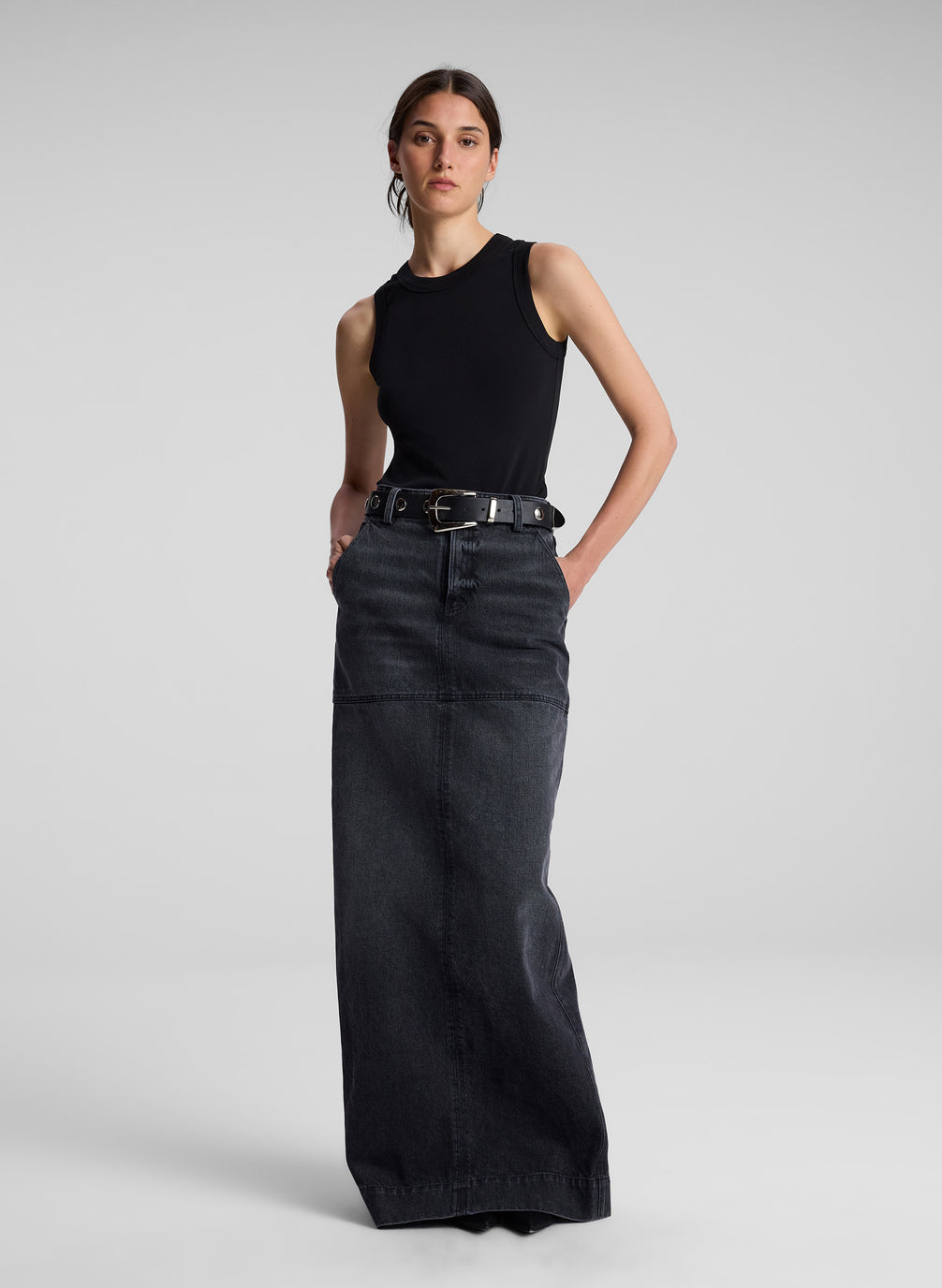 woman wearing black tank top and black denim maxi skirt