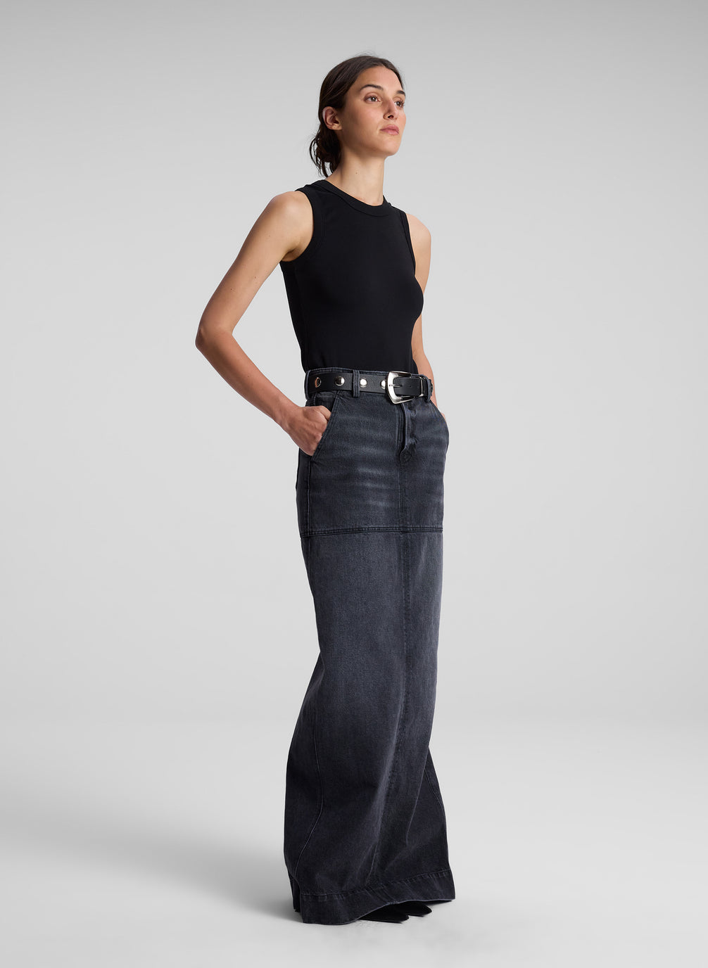 woman wearing black tank top and black denim maxi skirt