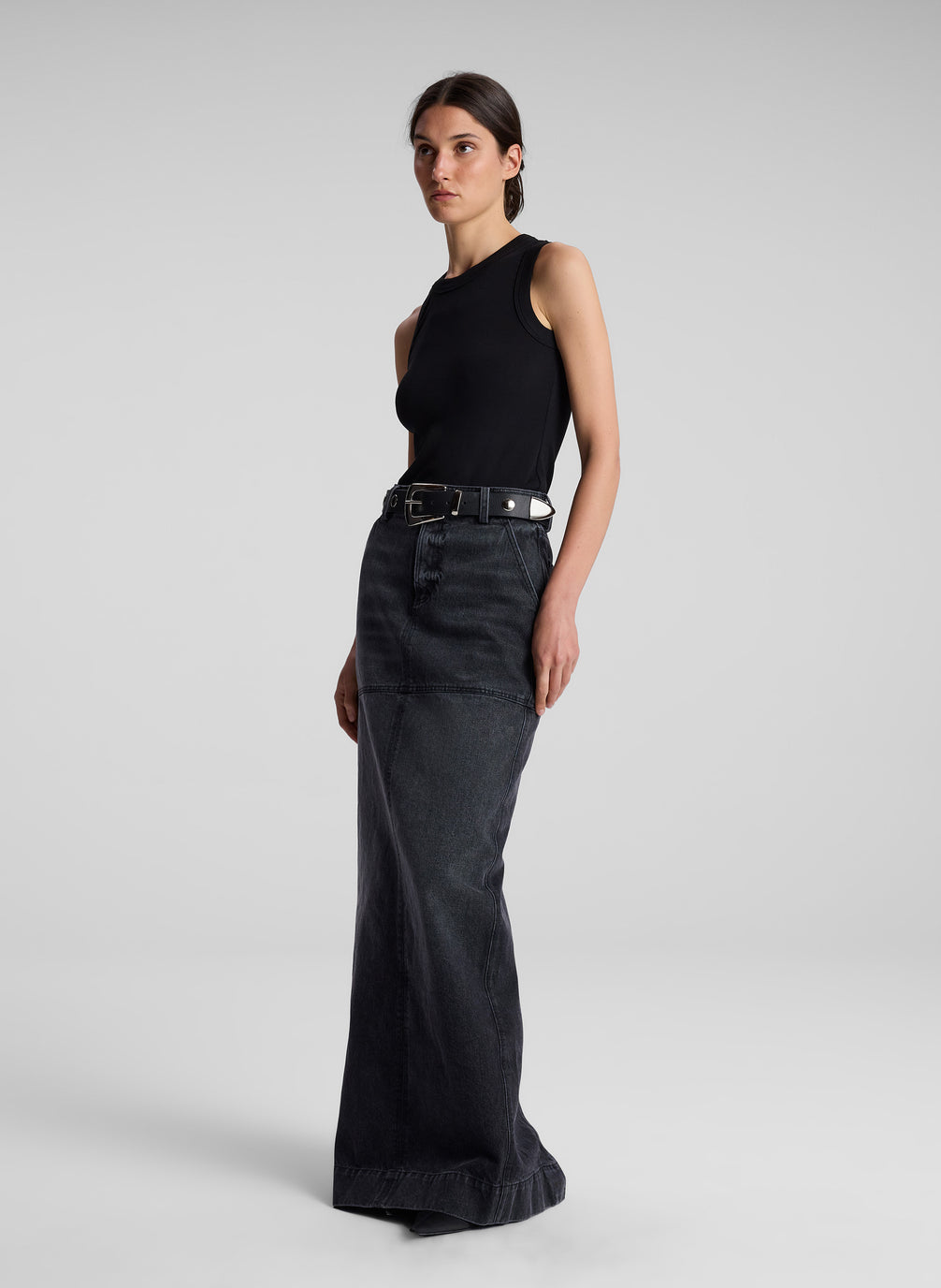 woman wearing black tank top and black denim maxi skirt