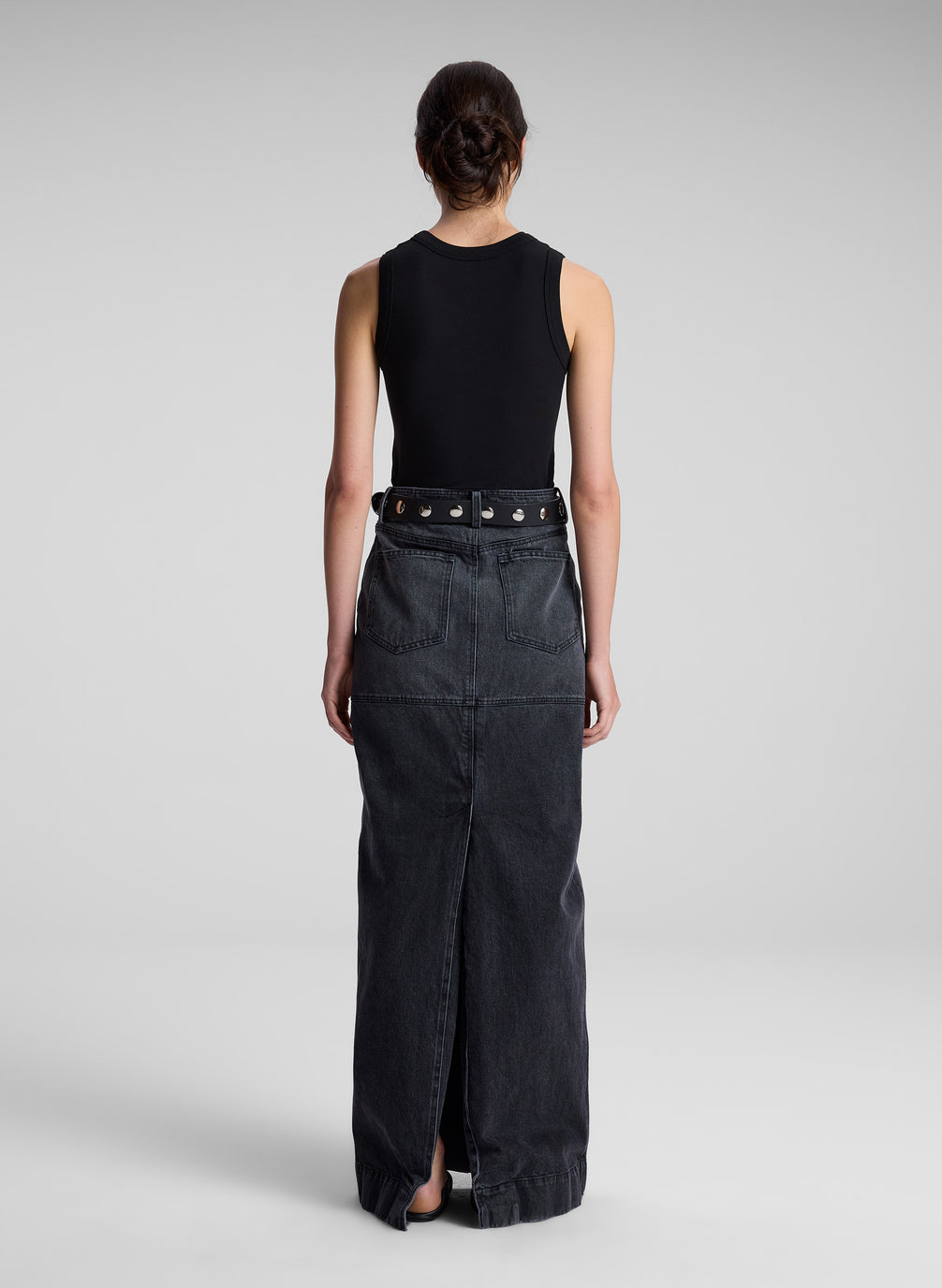 woman wearing black tank top and black denim maxi skirt