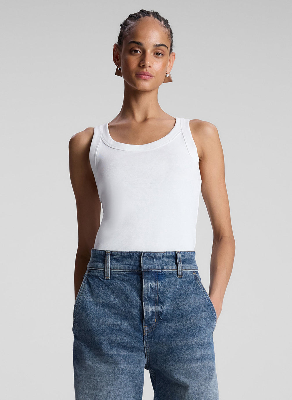 woman wearing white tank top and jeans