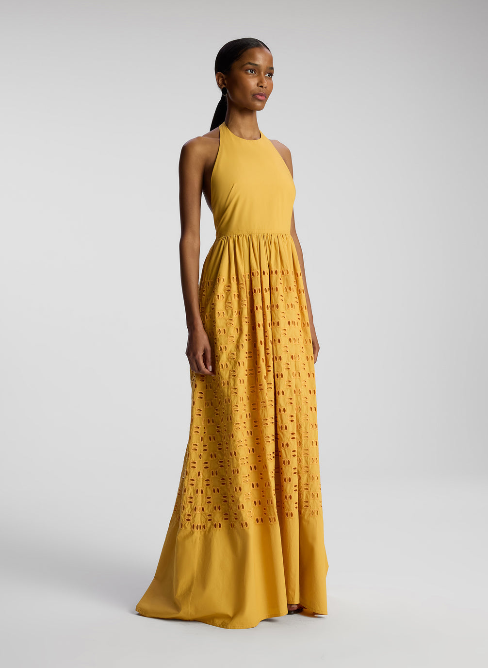 side view of woman wearing yellow maxi dress