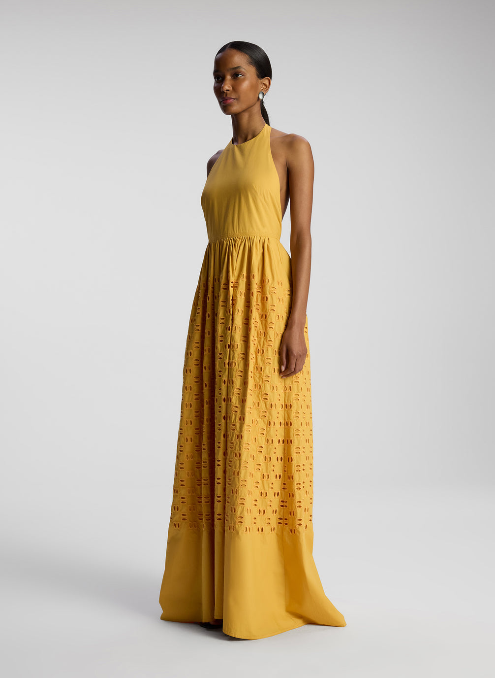 side view of woman wearing yellow maxi dress