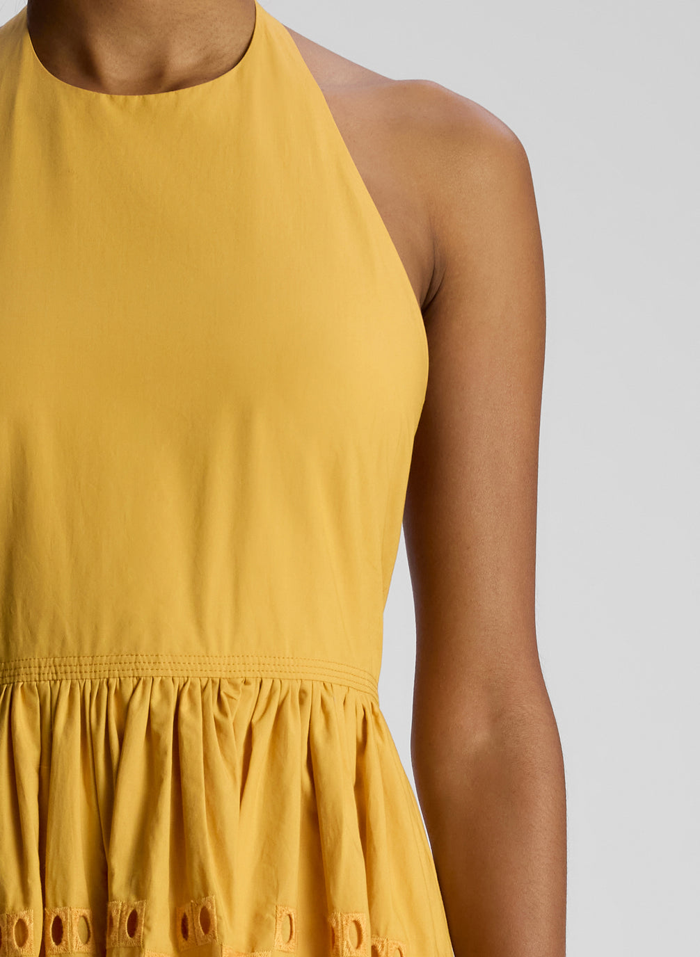 detail view of woman wearing yellow maxi dress