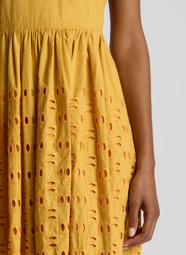 detail view of woman wearing yellow maxi dress