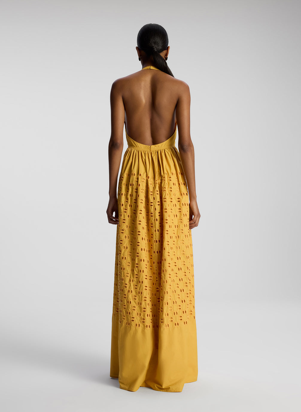 back view of woman wearing yellow maxi dress