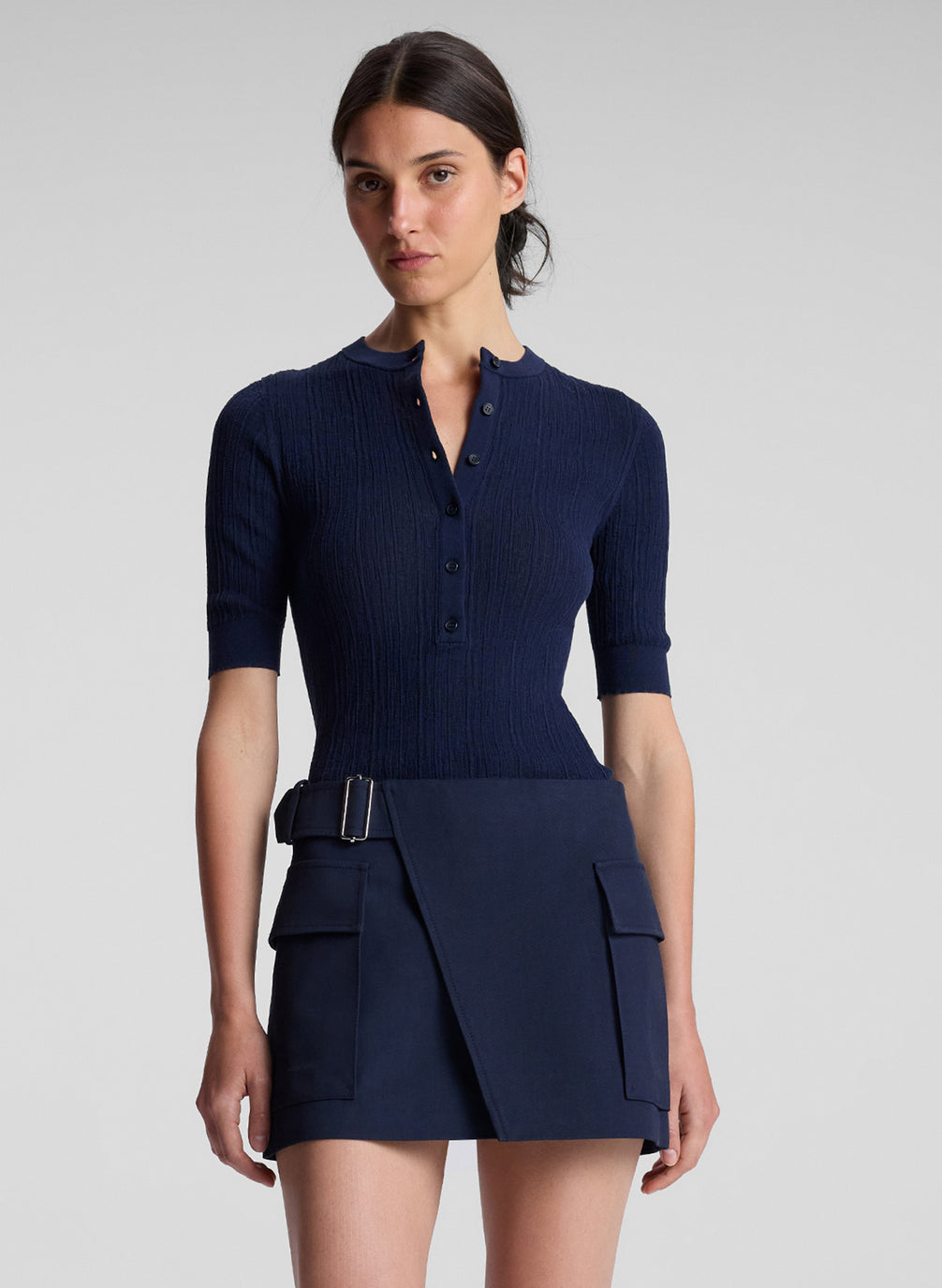 woman wearing navy blue top and navy blue mini skirt