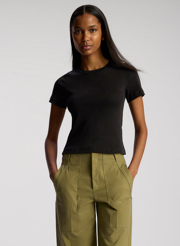 detail view of woman wearing black tshirt and olive green pants