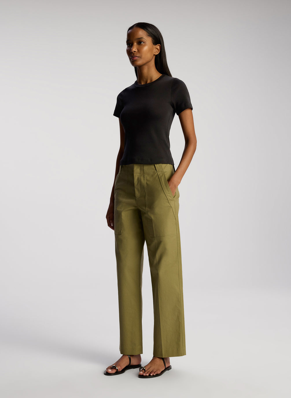 side view of woman wearing black tshirt and olive green pants