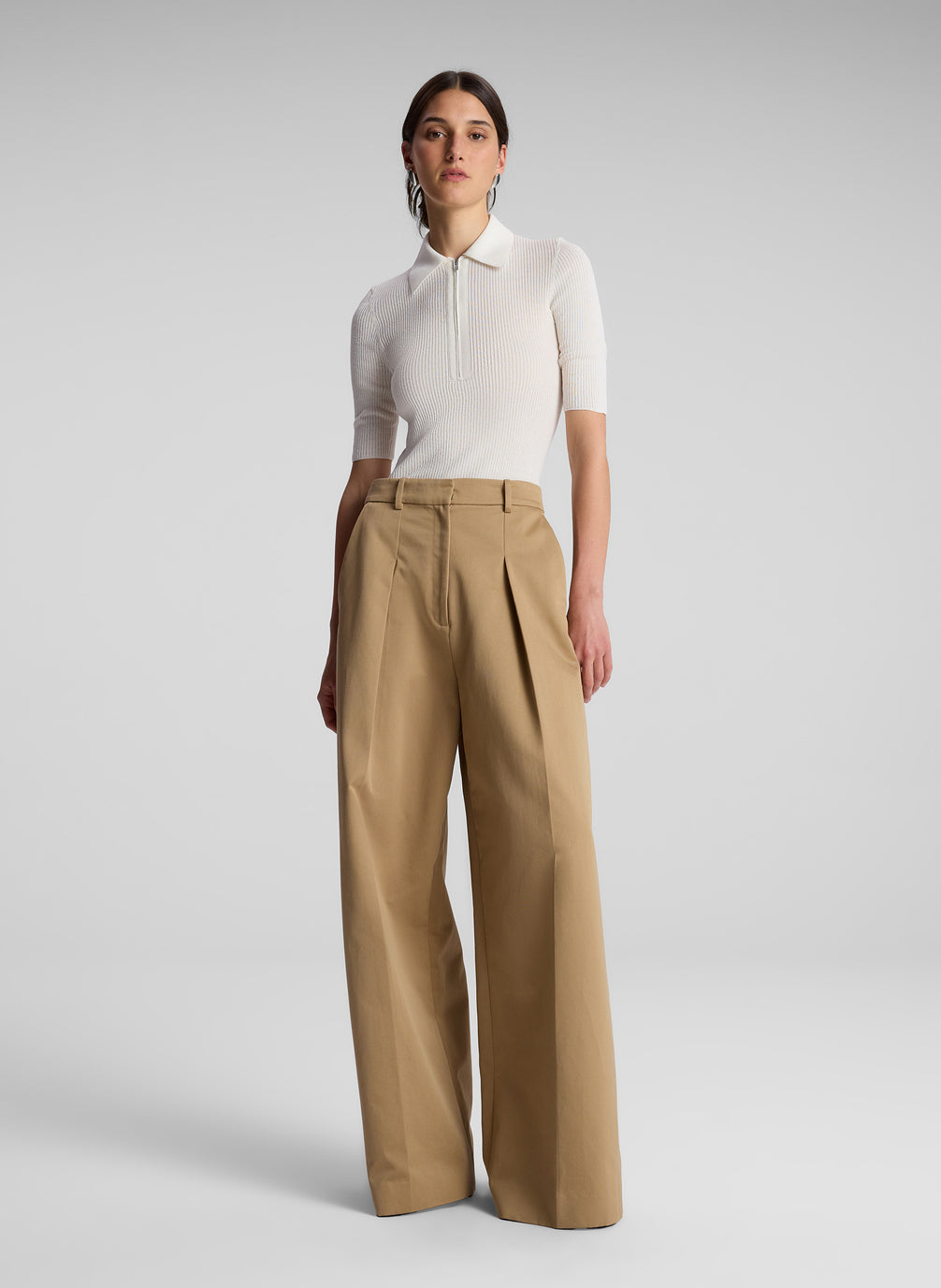 woman wearing white short sleeve collared shirt and khaki pants