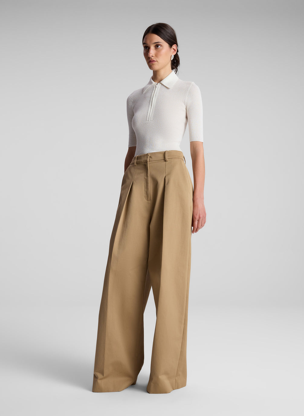 woman wearing white short sleeve collared shirt and khaki pants