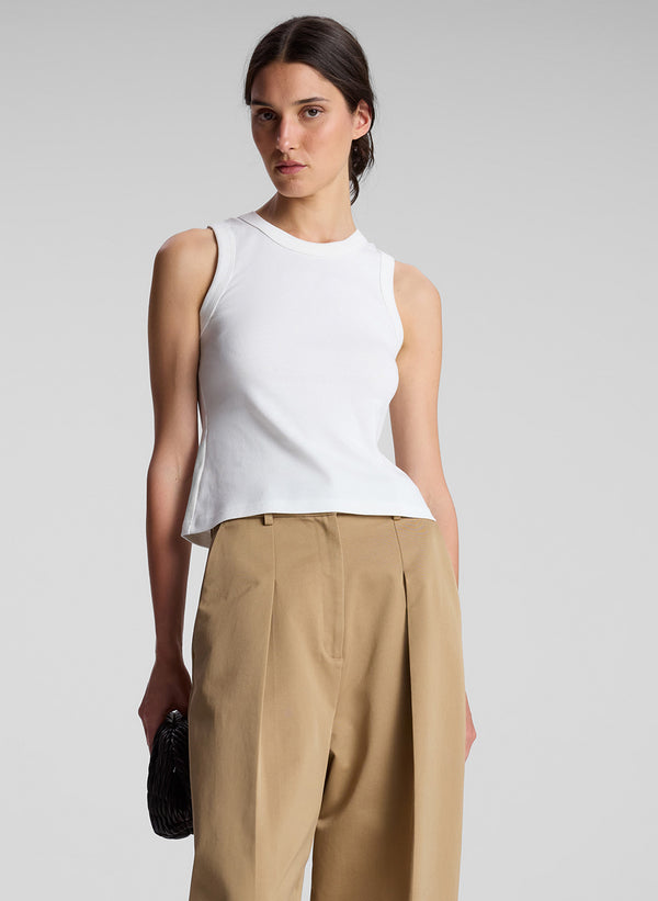 woman wearing white tank top and khaki pants