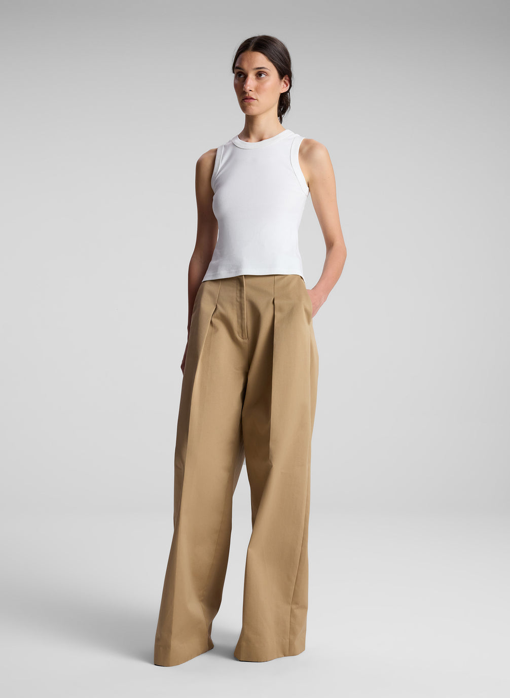 woman wearing white tank top and khaki pants