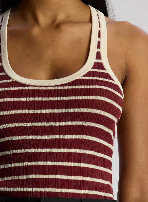 detail view of woman wearing burgundy striped tank top and black cargo pants