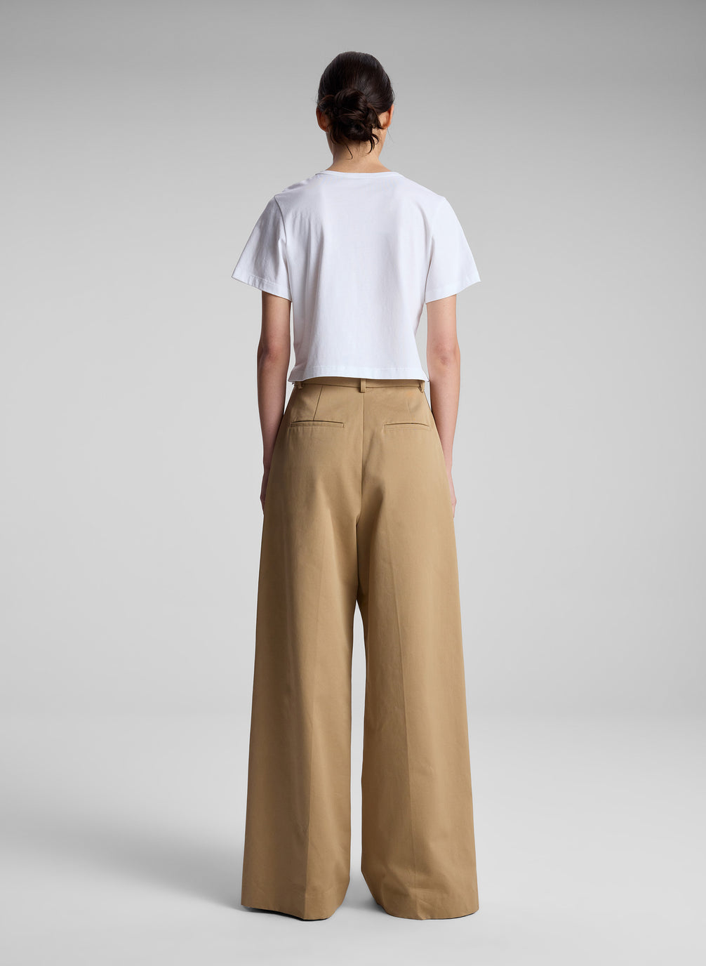 woman wearing white t shirt and khaki pants