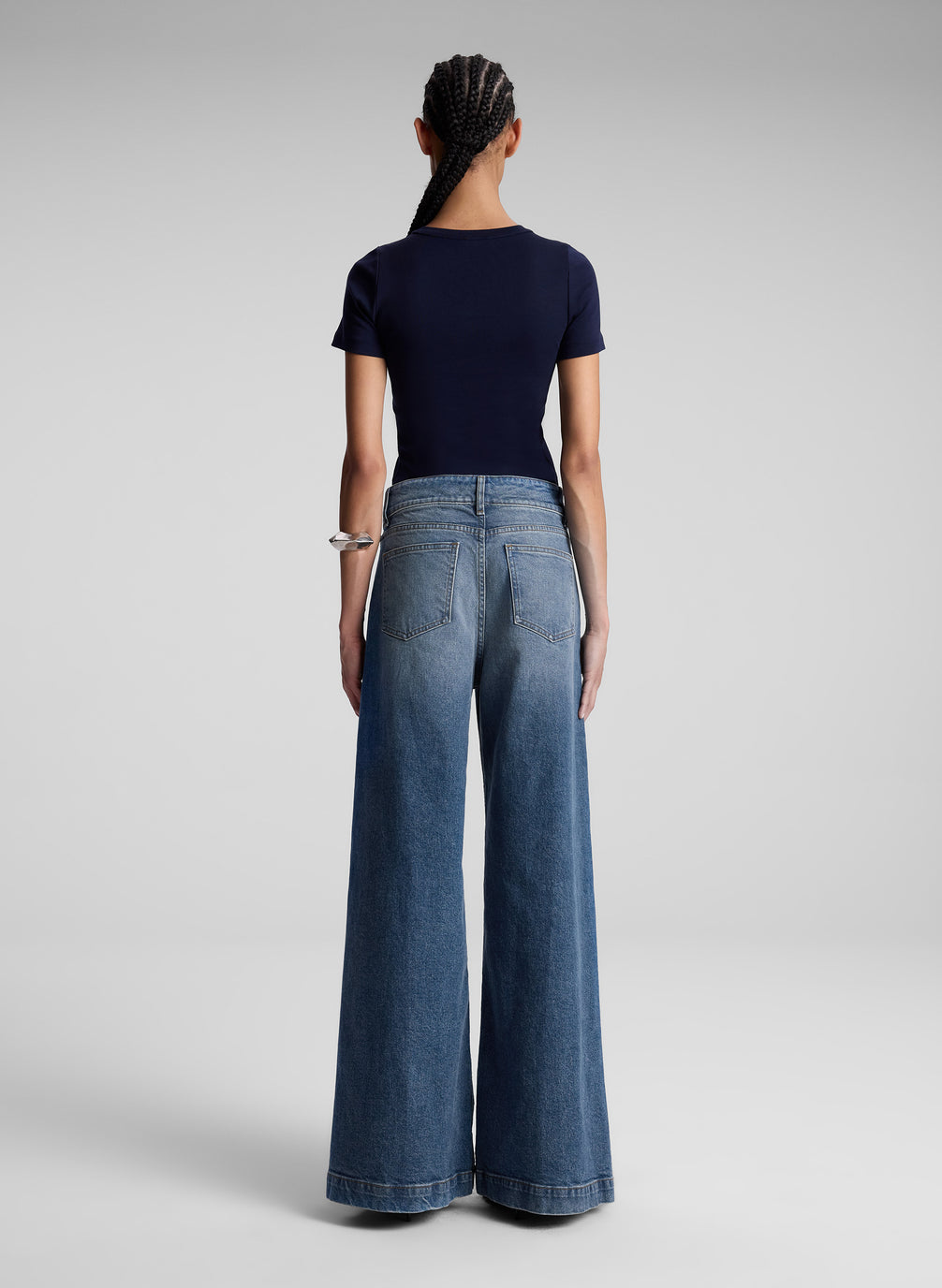 woman wearing navy blue tshirt and wide leg jeans