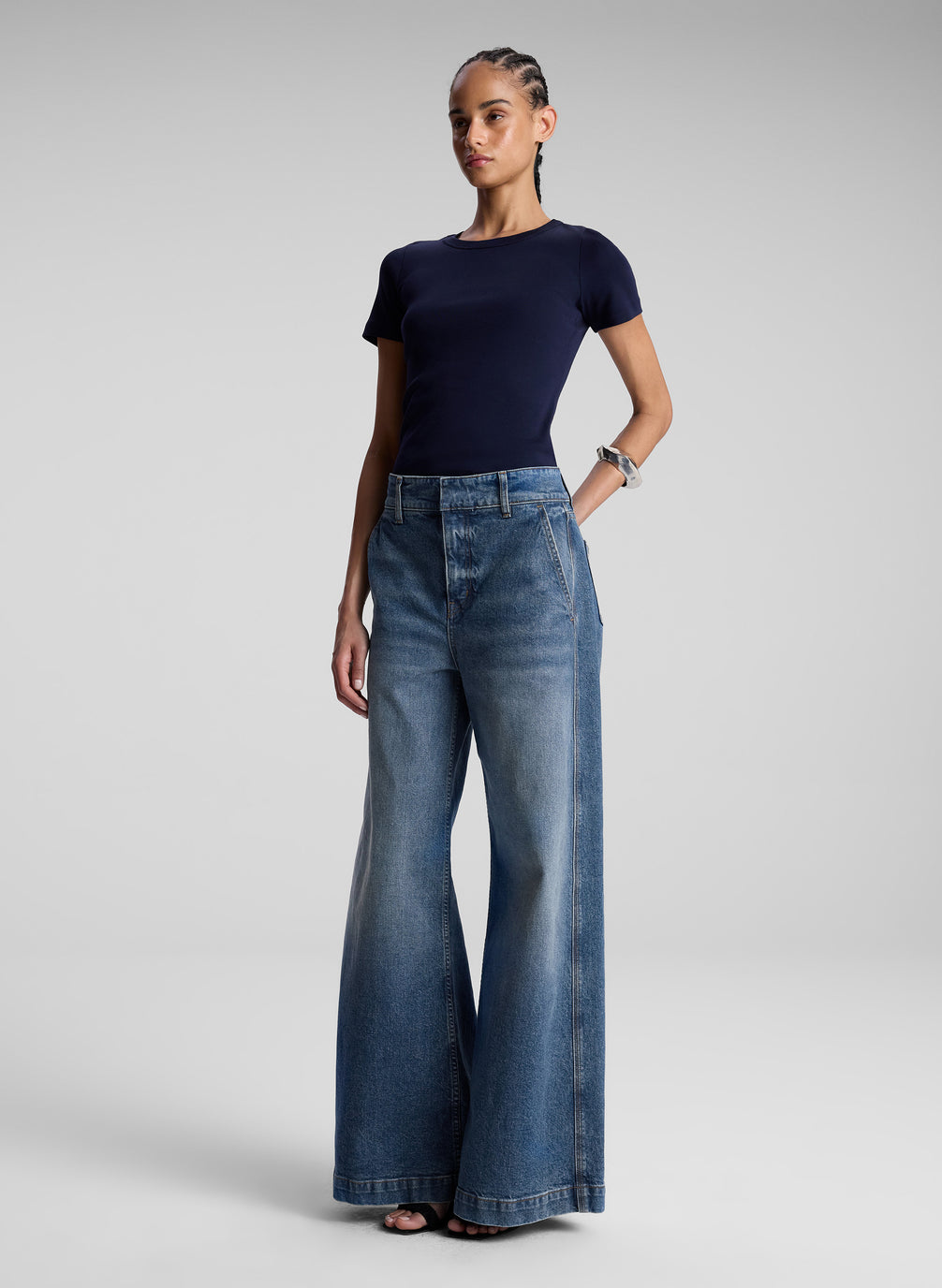 woman wearing navy blue tshirt and wide leg jeans