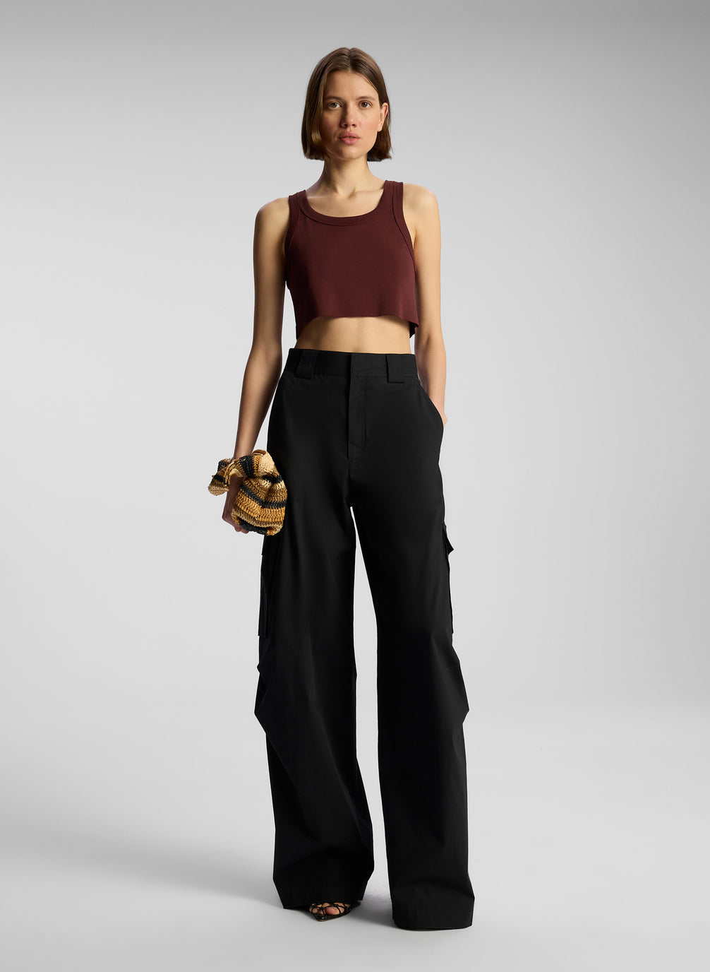 front view of woman wearing brown tank top and black cargo pants