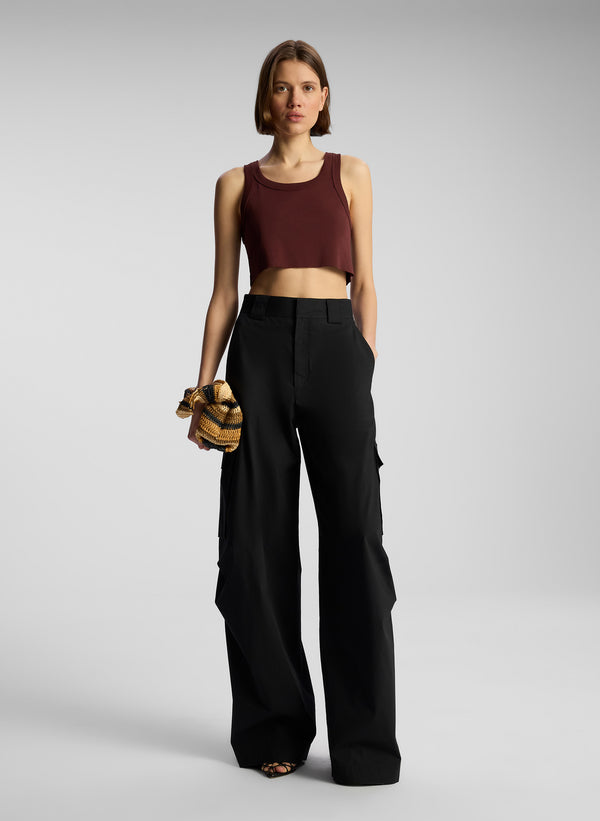 front view of woman wearing brown tank top and black cargo pants