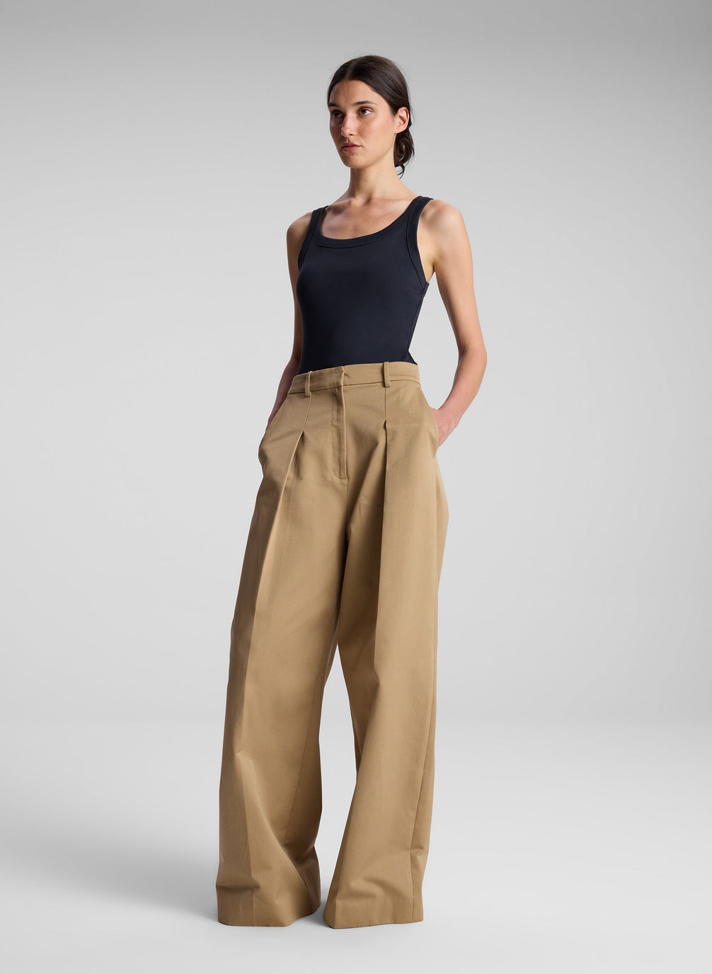 woman wearing black tank top and khaki pants