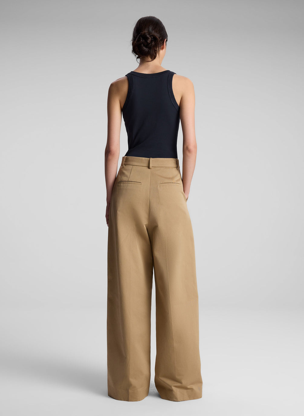 woman wearing black tank top and khaki pants