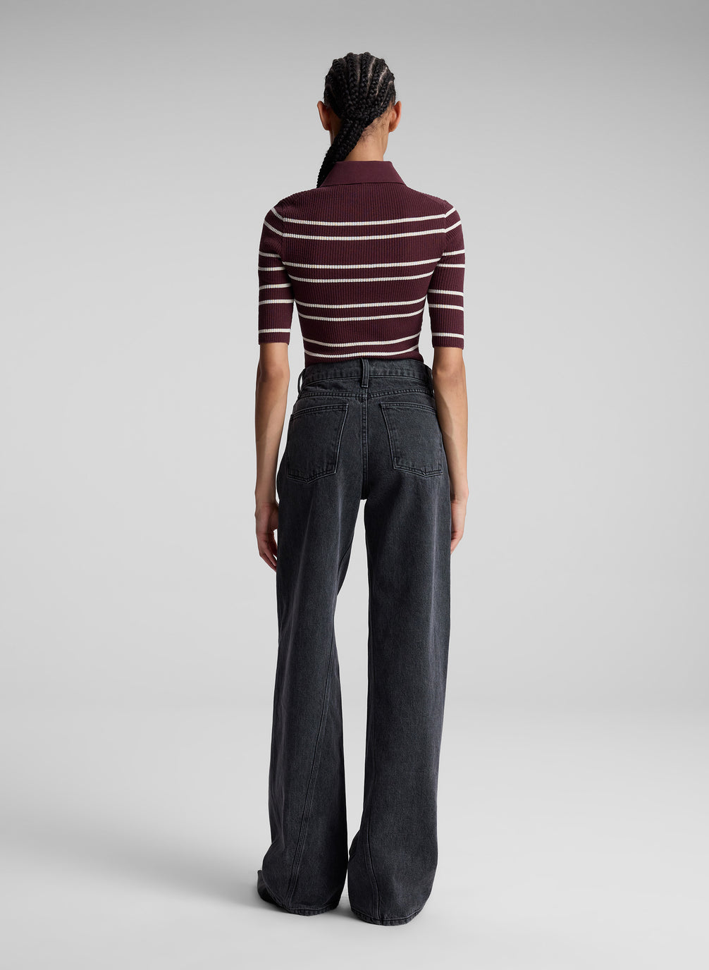 woman wearing carob striped shirt and jeans