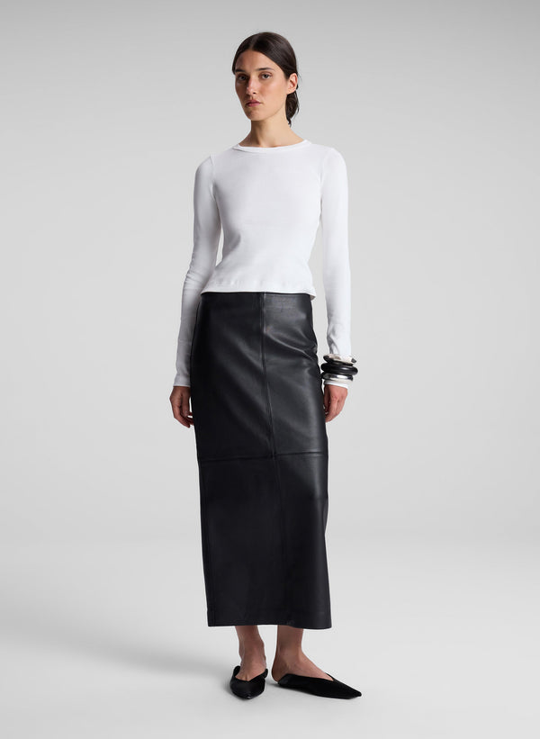 woman wearing white long sleeve tee and black maxi skirt