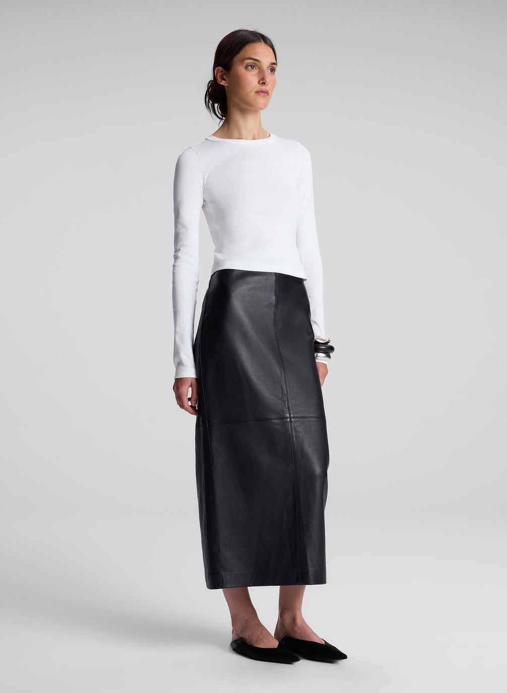 woman wearing white long sleeve tee and black maxi skirt