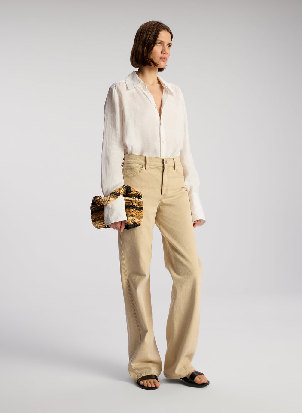 Woman Carrying Striped Raffia Handbag