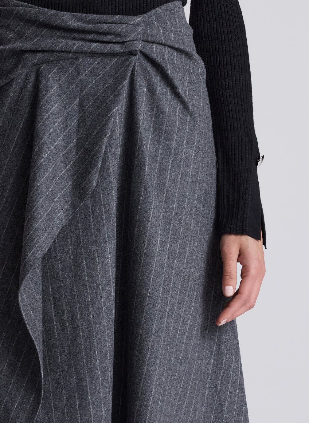 woman wearing black turtleneck and grey pinstriped midi skirt