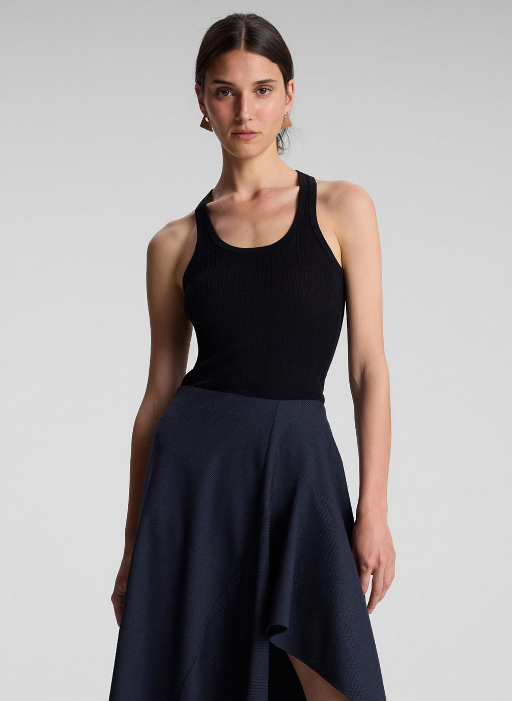 woman wearing black tank top and blue skirt