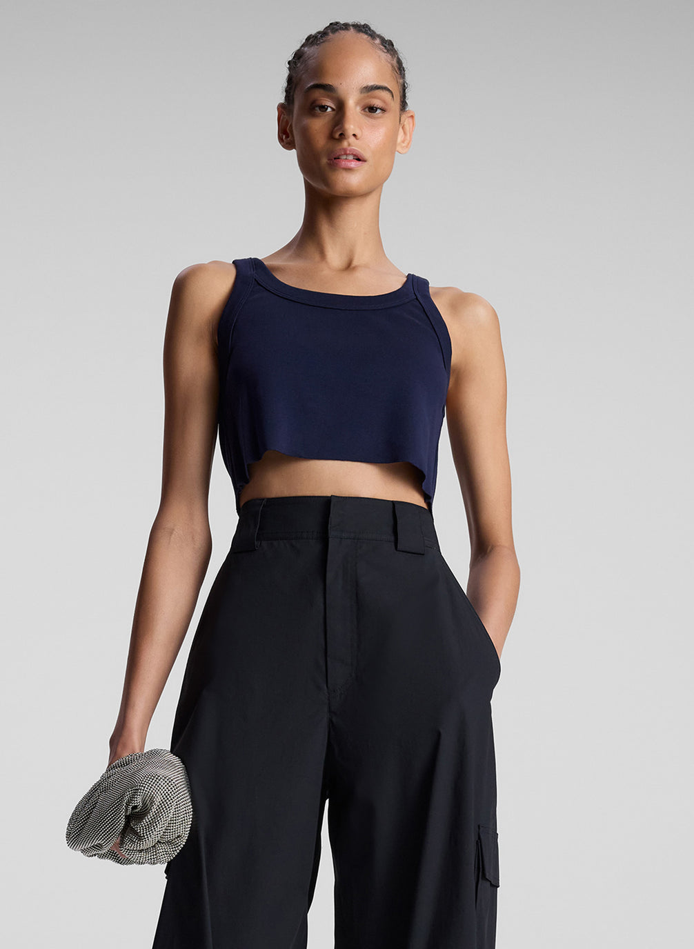 woman wearing navy blue cropped tank top and black pants