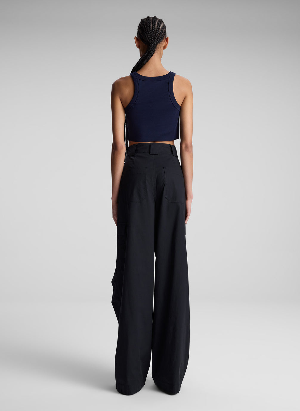 woman wearing navy blue cropped tank top and black pants