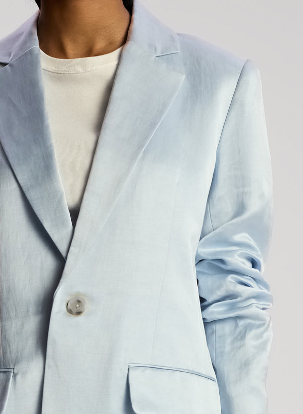 detail view of woman wearing light blue blazer with matching shorts