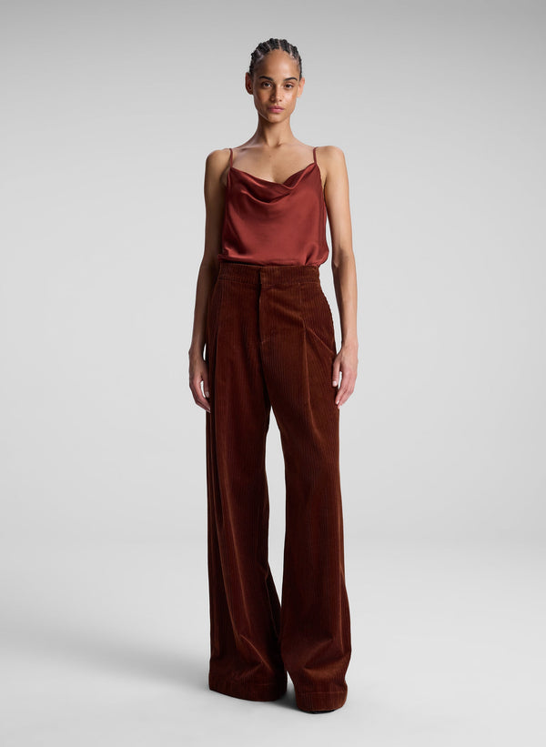 woman wearing red camisole top and maroon pants