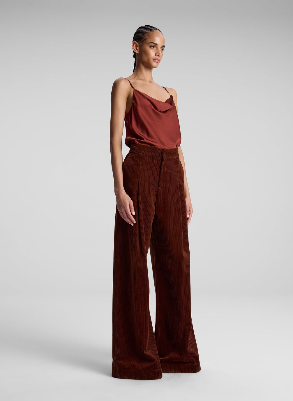 woman wearing red camisole top and maroon pants