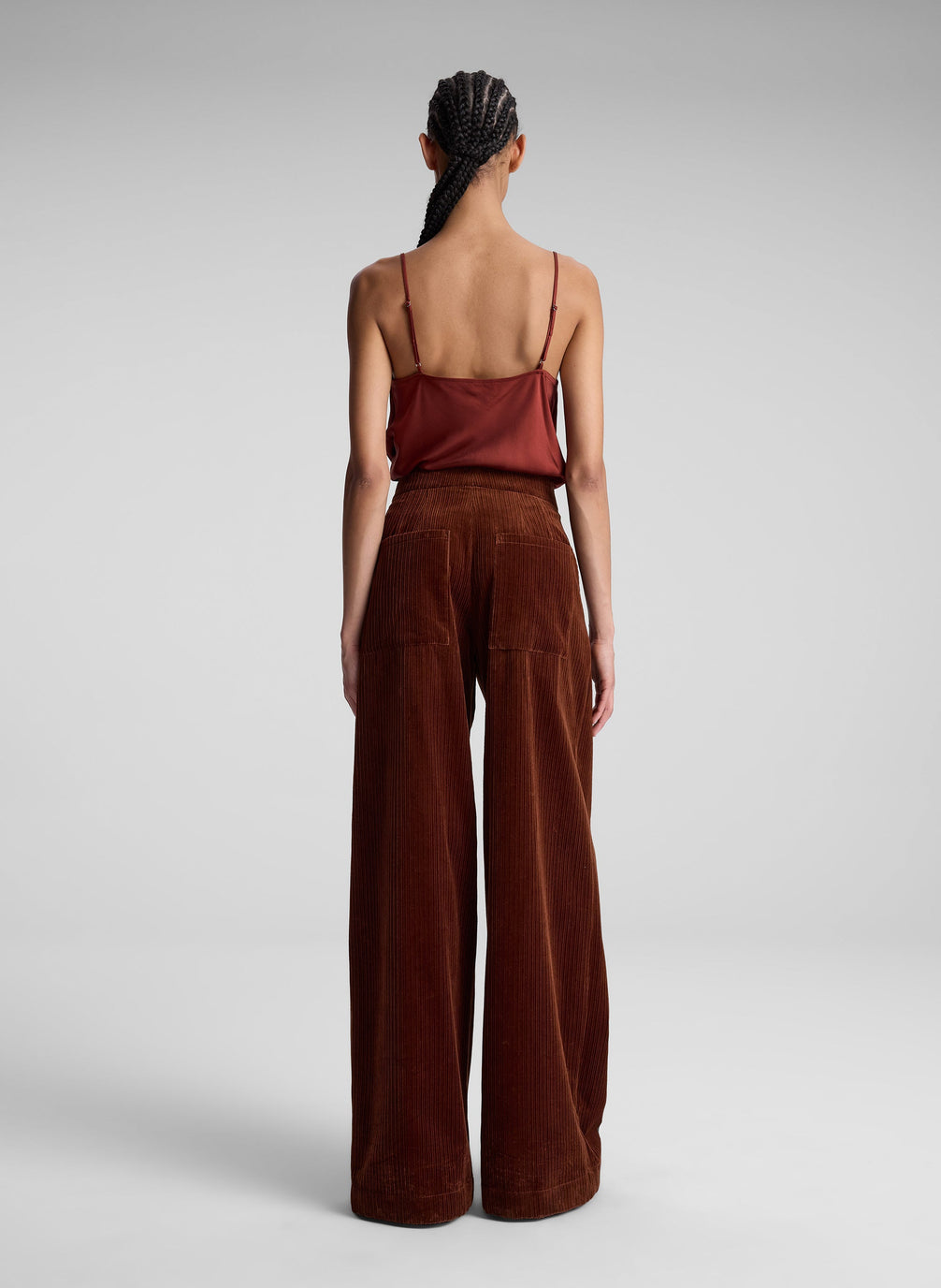 woman wearing red camisole top and maroon pants