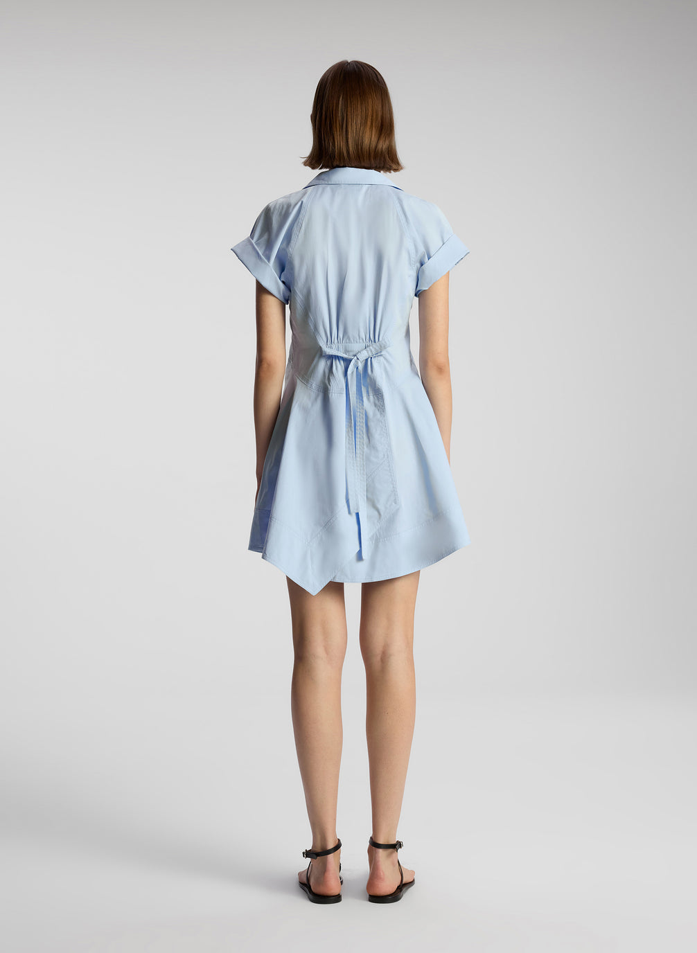 back view of woman wearing light blue mini shirtdress