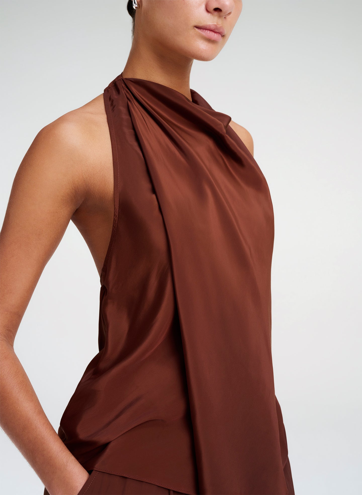 Brown halter top worn by a model on a white background