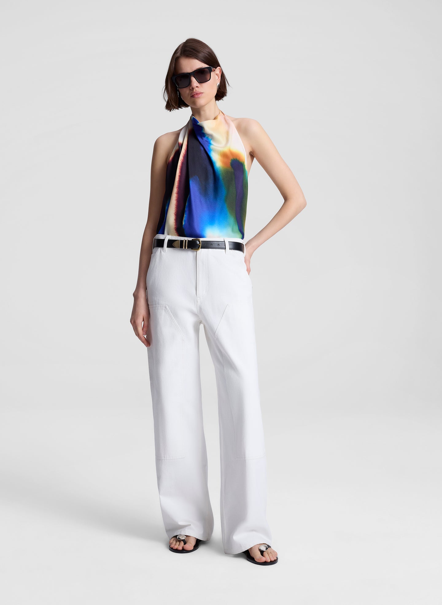 woman wearing multicolor halterneck top and white pants