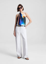 woman wearing multicolor halterneck top and white pants