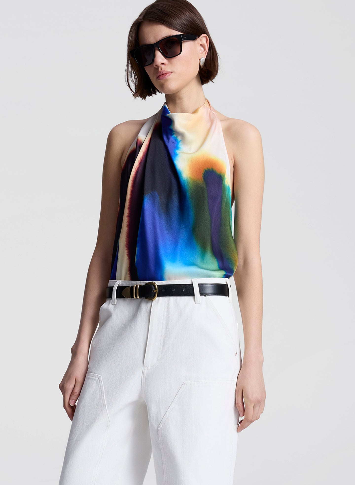 woman wearing multicolor halterneck top and white pants
