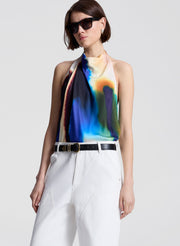 woman wearing multicolor halterneck top and white pants