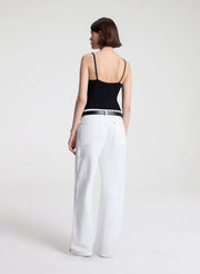 woman wearing black lace camisole and white denim jeans