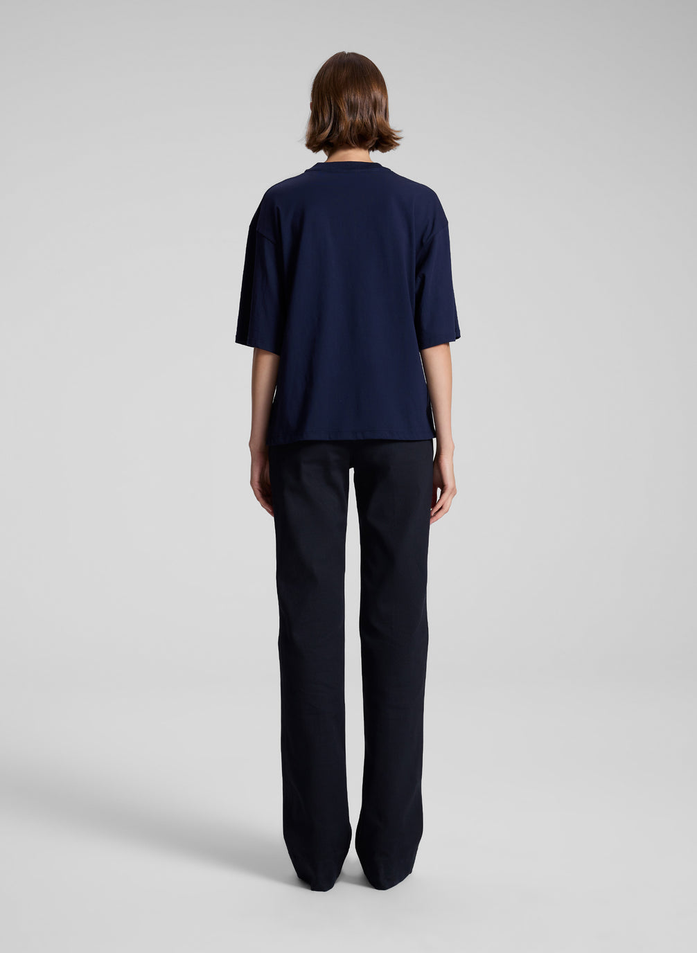 woman wearing navy t shirt and navy blue pants