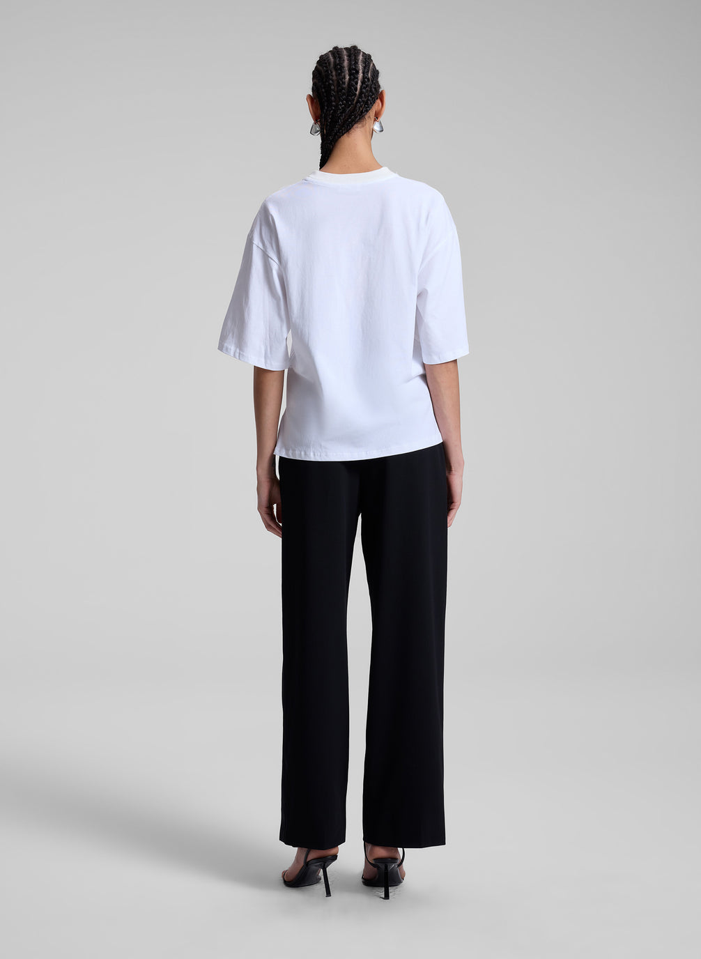 woman wearing white t shirt and black pants